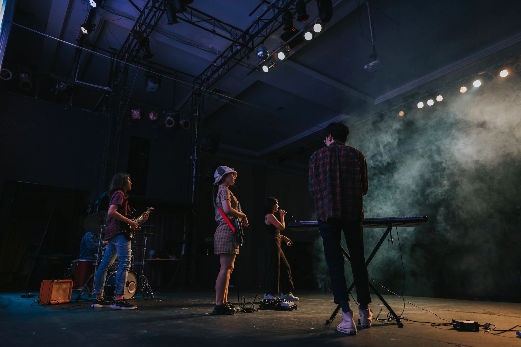 Band performing on stage with energetic crowd